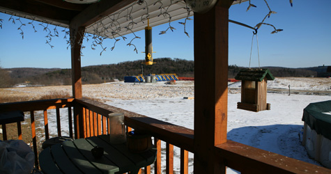 A drill site is seen from the back of Dimock resident Ronald Carter's home. Carter was told the methane coming from his pipes shouldn't be a problem as long as he cracked a window while running the tap. (Abrahm Lustgarten/ProPublica)