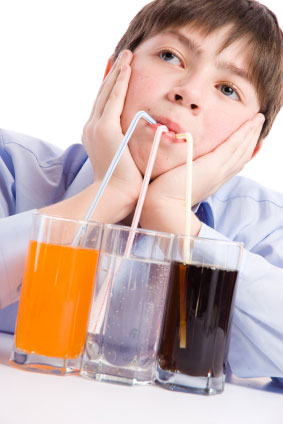 Boy sipping soda and water