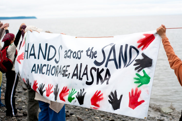 Hands across a beach.