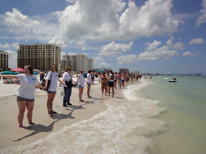 Hands across a beach.