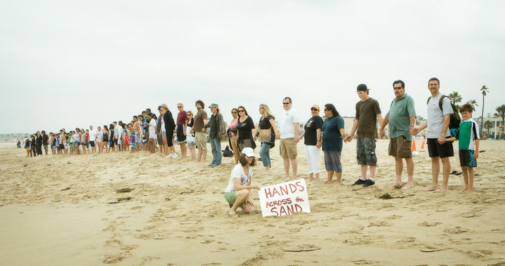 Hands across a beach.