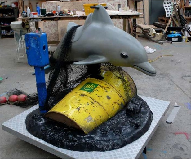 Banksy dolphin ride with BP oil barrel