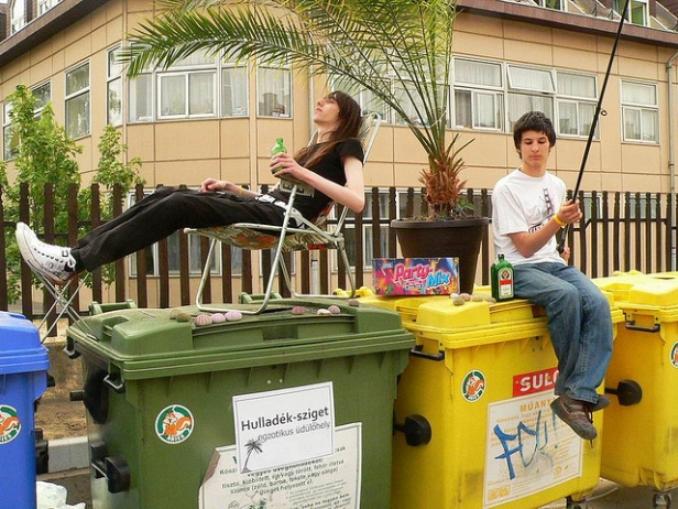 teens relaxing on recycling bin paradise