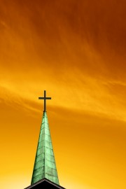 Green cross against orange sky