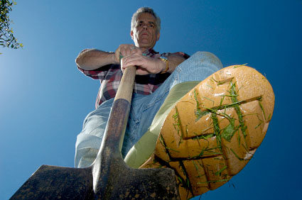 Man leaning on shovel