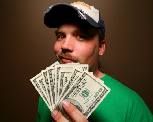 Man holding hundred-dollar bills