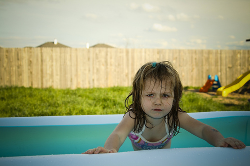 Girl by swimming pool