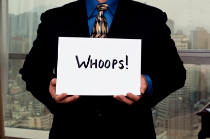 man holding "whoops" sign