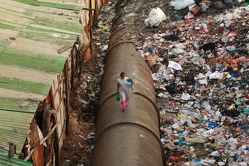 Woman walks a water pipe.