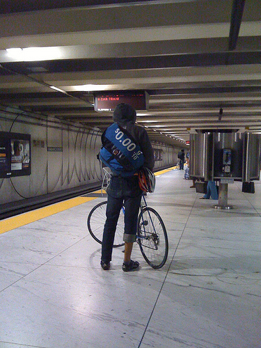 guy w/ bike, zero per gallon sign