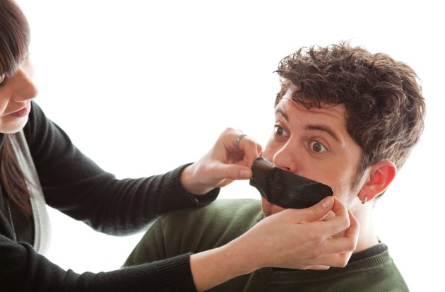 Woman lifting gag on man.