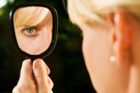 woman looking in mirror