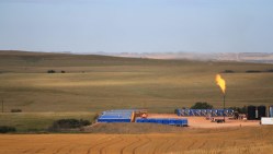 Excess gas flares off at a well site outside Williston.