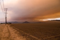 Smoke from the Springs Fire blows over a dry Californian landscape.