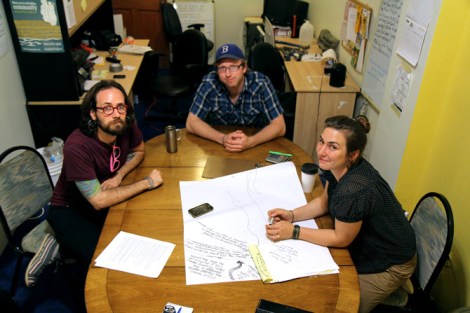 From left: Occupy Sandy organizers Brett Goldberg, Gabriel Van Houten, and Terri Bennett discuss the future of the movement in the back offices of the Pilgrim Church of Arverne.