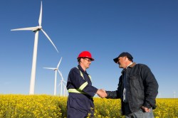 farmer and engineer with wind turbines