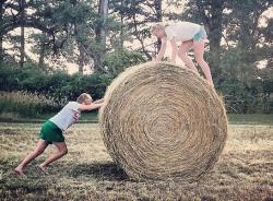 Caitrin and Lake horsing around with hay bales in Nebraska.