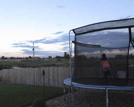 Sunset, trampoline, fracking rig.