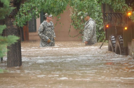 Two Colorado National Guardsmen waist deep in Boulder floodwaters.