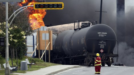 A firefighter walks past a burning train wagon at Lac Megantic, Quebec, July 6, 2013.