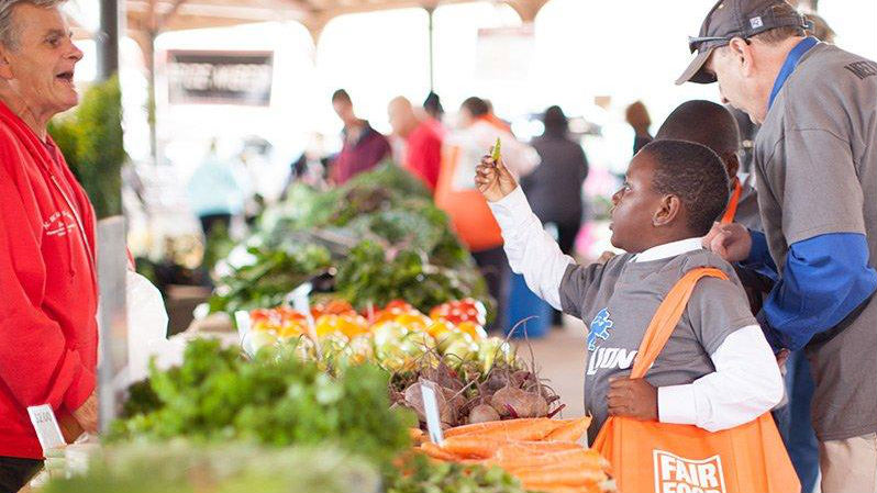 Oran Hesterman (at left). Photo from the Fair Food Network's partnership with the Detroit Lions and Eastern market working with kids from Detroit Public School