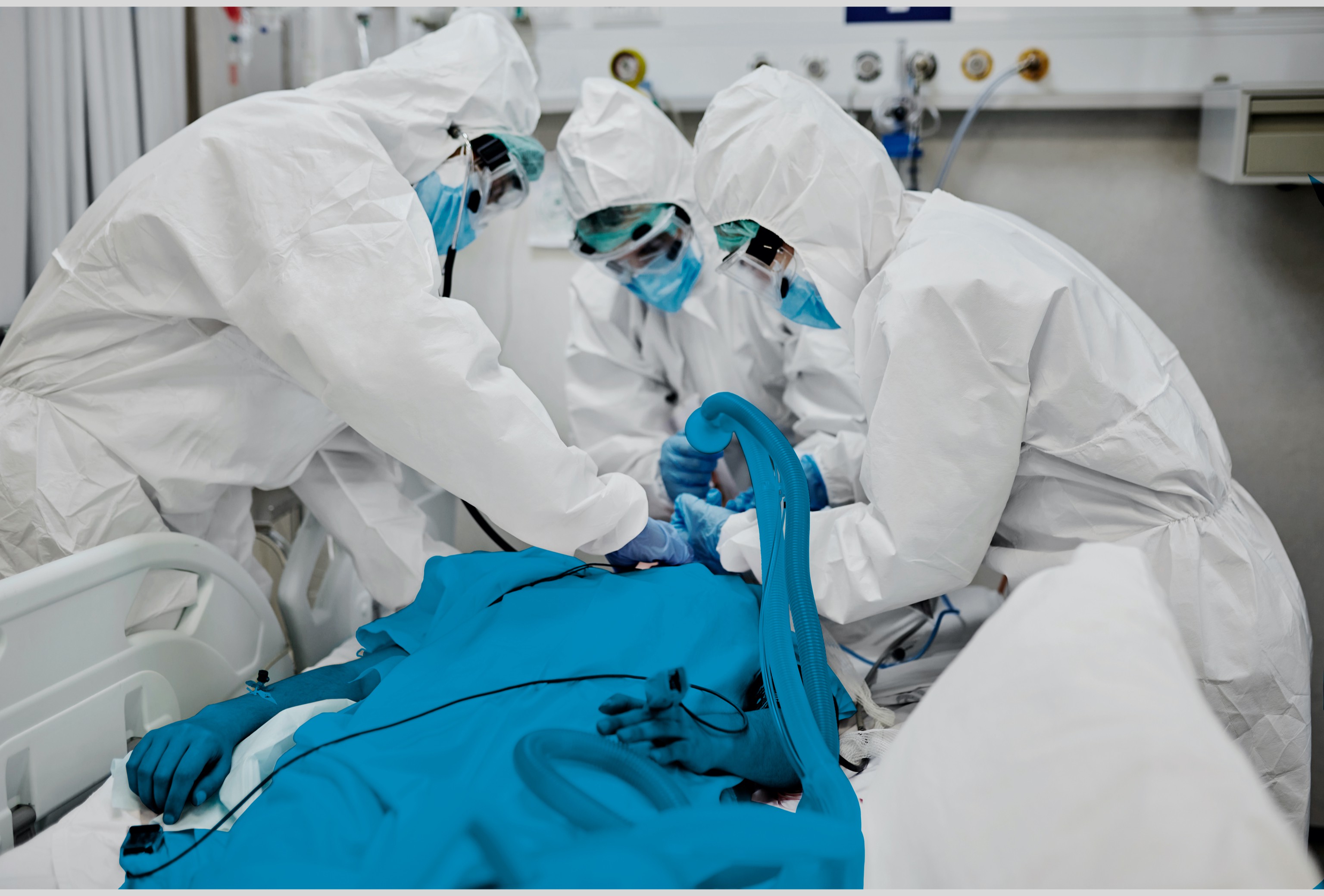 Doctors administer a medical ventilator to a patient.