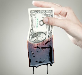 dollar bill dripping with oil