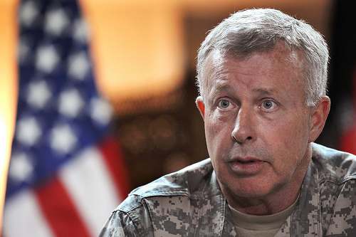 Army general in front of flag