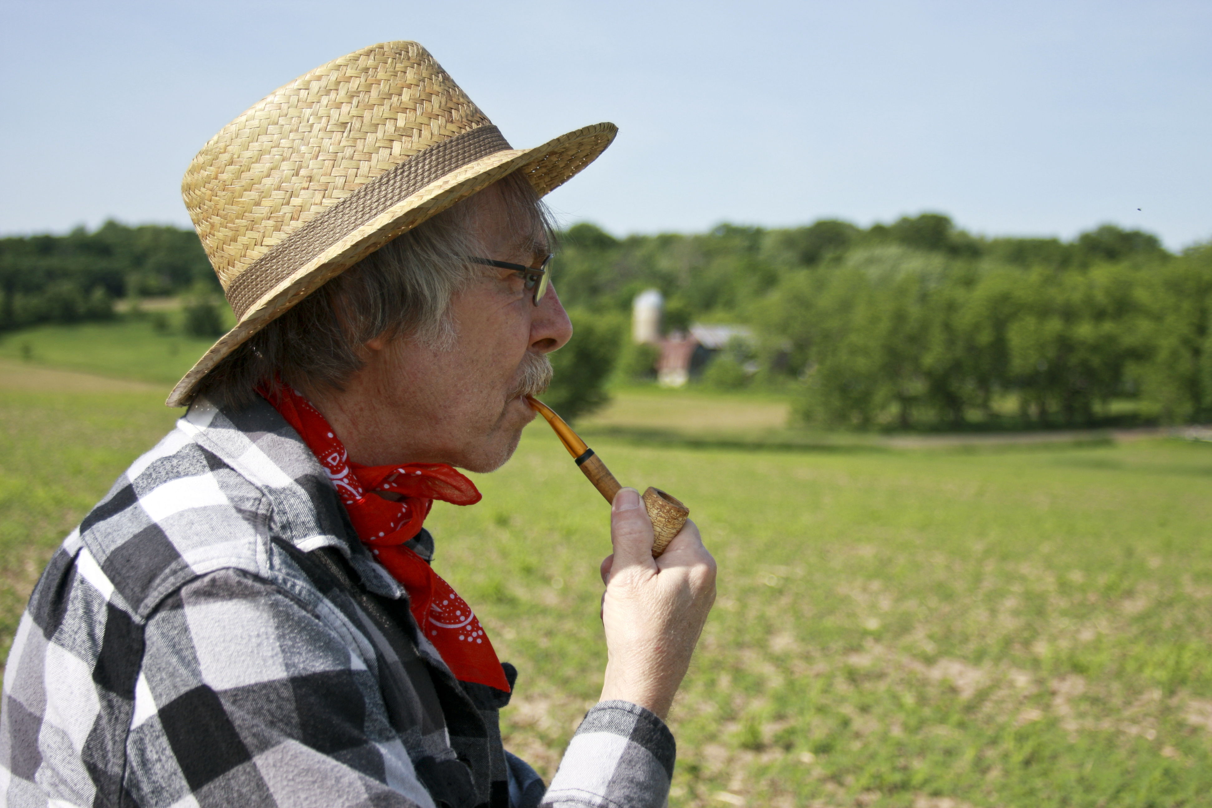 man smoking corn cob pipe