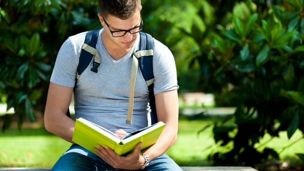 man reading green book