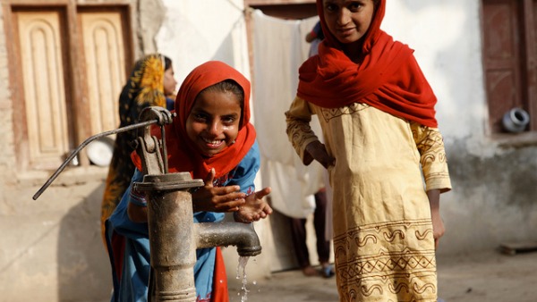 Children in Sindh, Pakistan, play at a water pump in a village near Dadu, in Sindh, Pakistan.