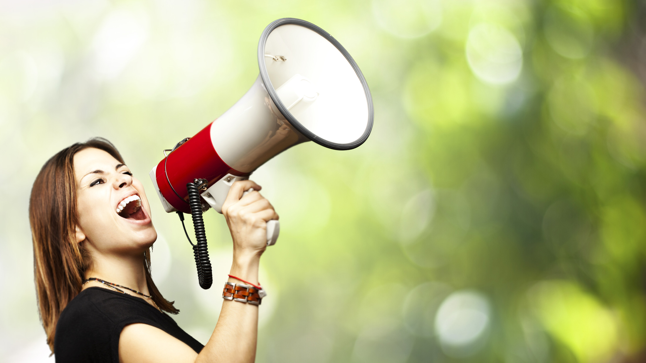 Woman yelling/announcing into megaphone