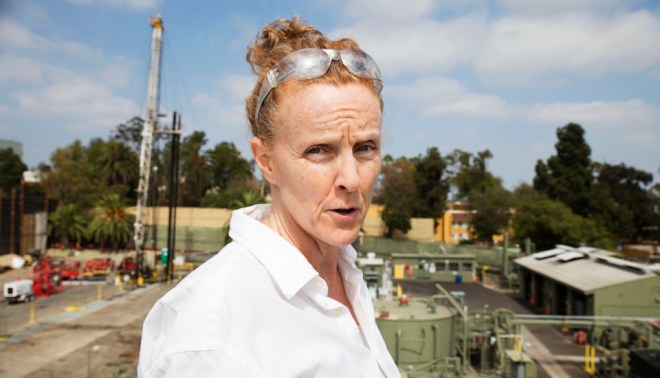 Donna Ann Ward stands on the roof of a neighboring building that overlooks the Murphy drilling site. She is the co-founder of CoWatchingOil LA, a neighborhood watchdog group that monitors drilling activity. 