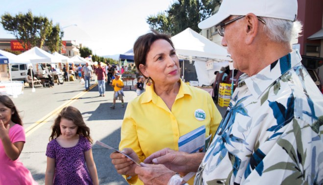 Margaret Morales Rebecchi hands out voter information on Measure J at the Hollister Farmers Market. 