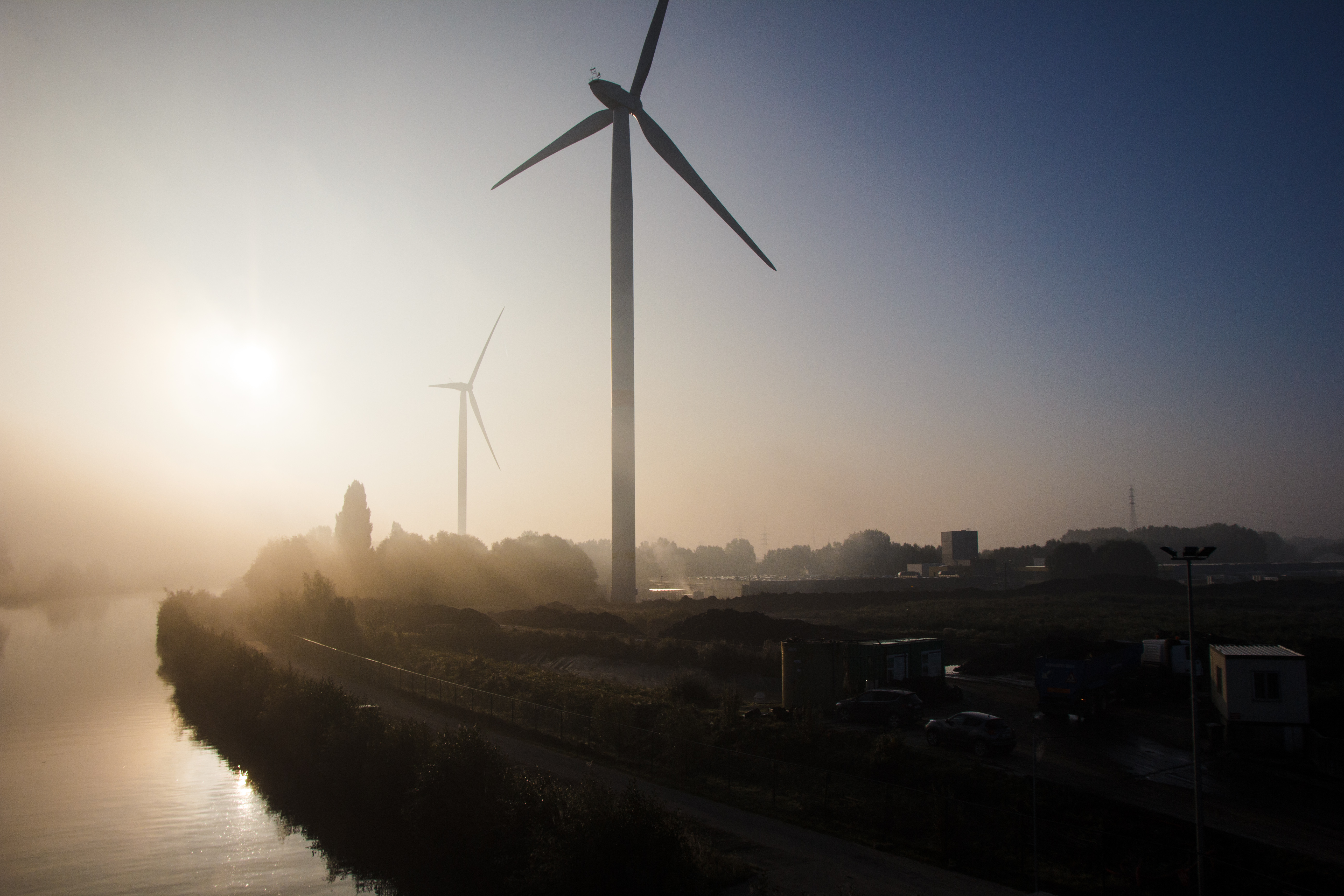 wind turbines with sunrise and fog