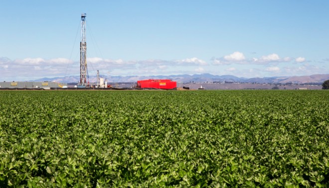 A oil drilling tower sits among celery plants near Santa Maria, Calif. Plans were recently approved for Santa Maria Energy to drill 381 new wells nearby. 