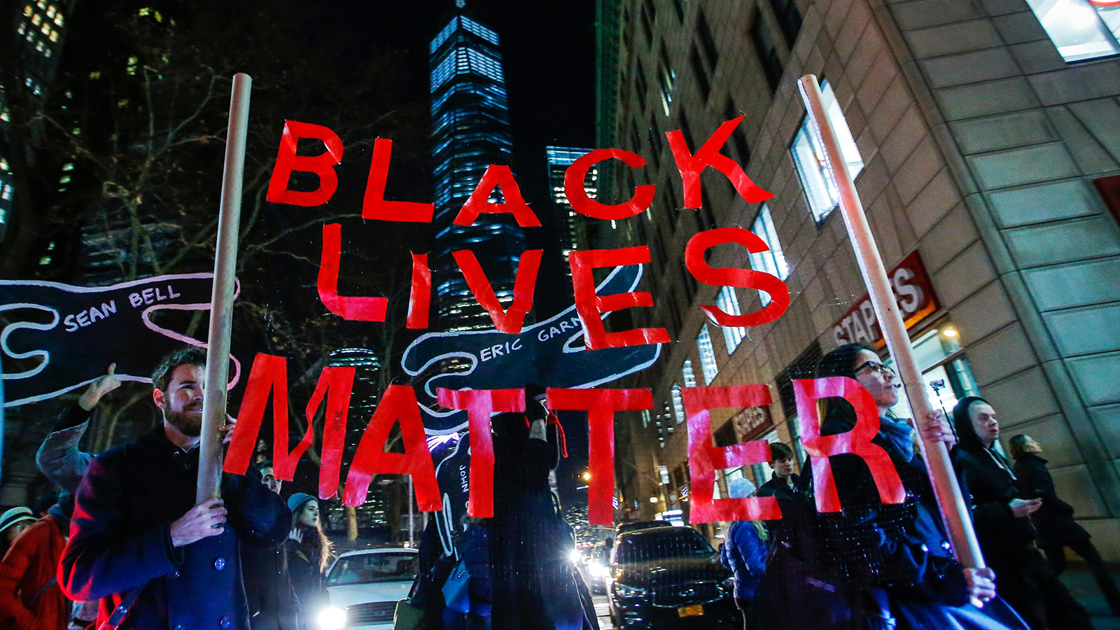 Protesters march next to One World Trade Center in Lower Manhattan in New York City as thousands of demonstrators take to the streets demanding justice for the death of Eric Garner, December 4, 2014.