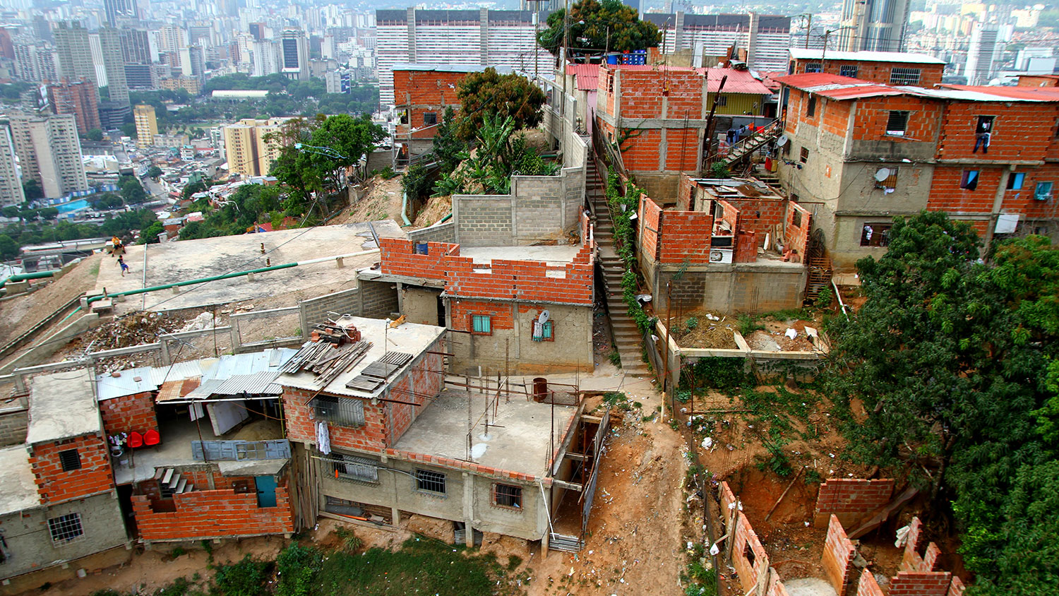 shanties in front of skyscrapers