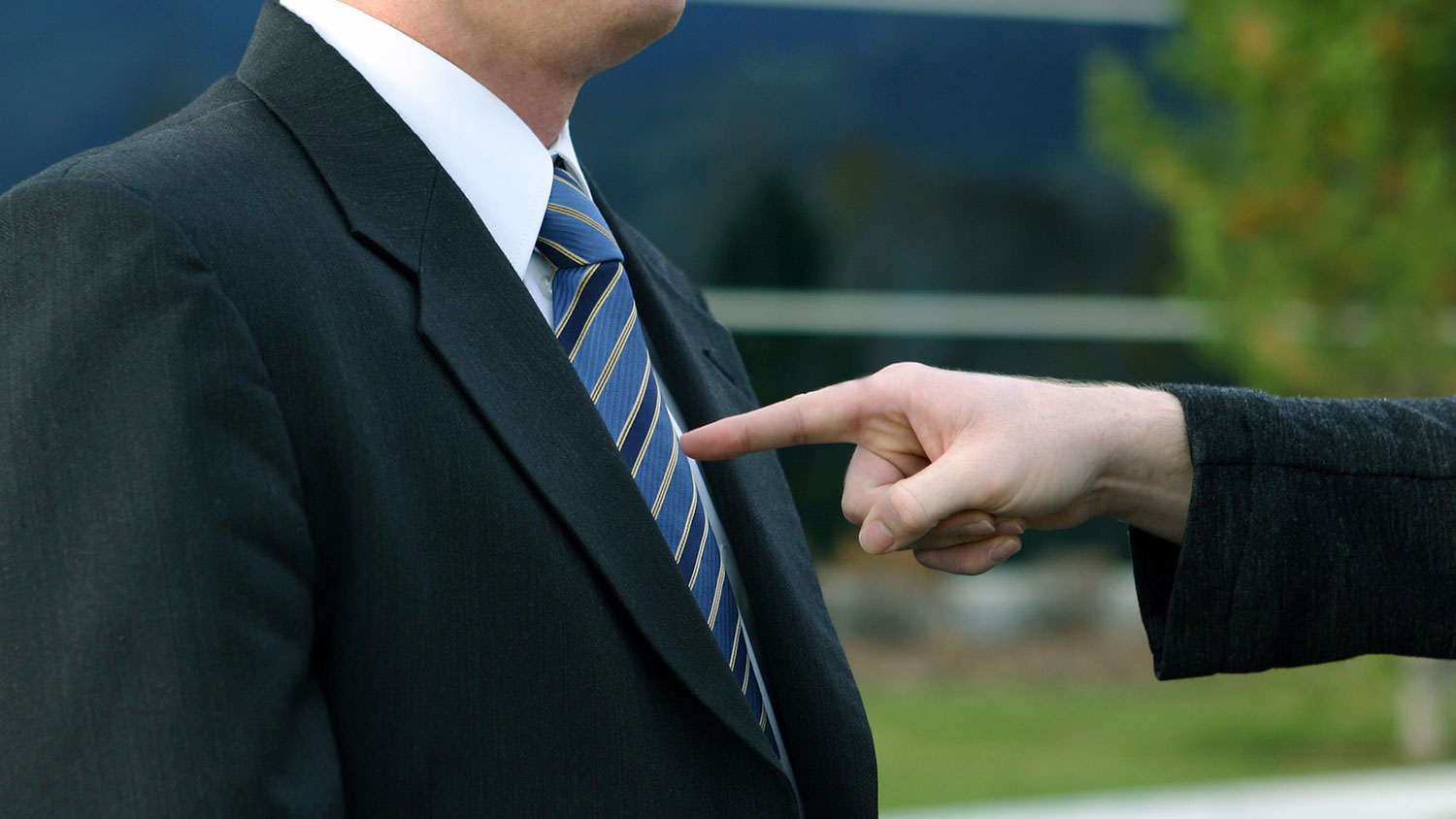 finger jabbing into man's chest