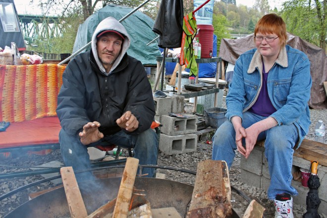 Chris Semrau and another Nickelsville resident warm themselves by a communal fire.