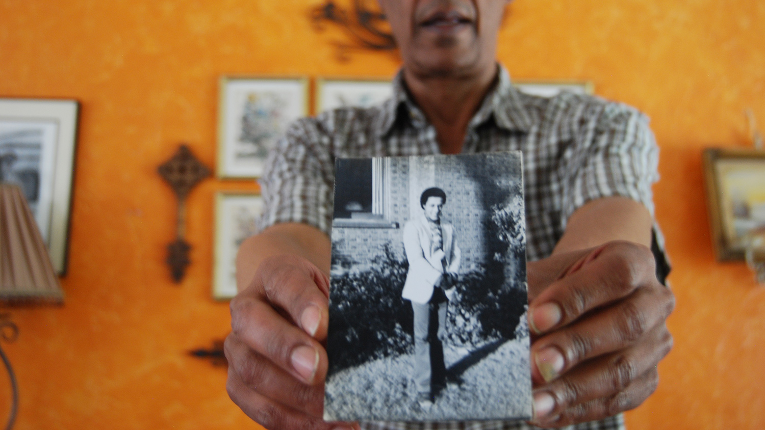 Tekola shows a photo of him taken on his first day of living in Seattle.