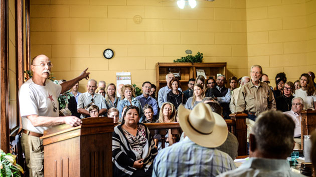 A lone pipeline supporter speaks to local officials and citizens at a county commissioners meeting in Marfa, Texas, on Tuesday.