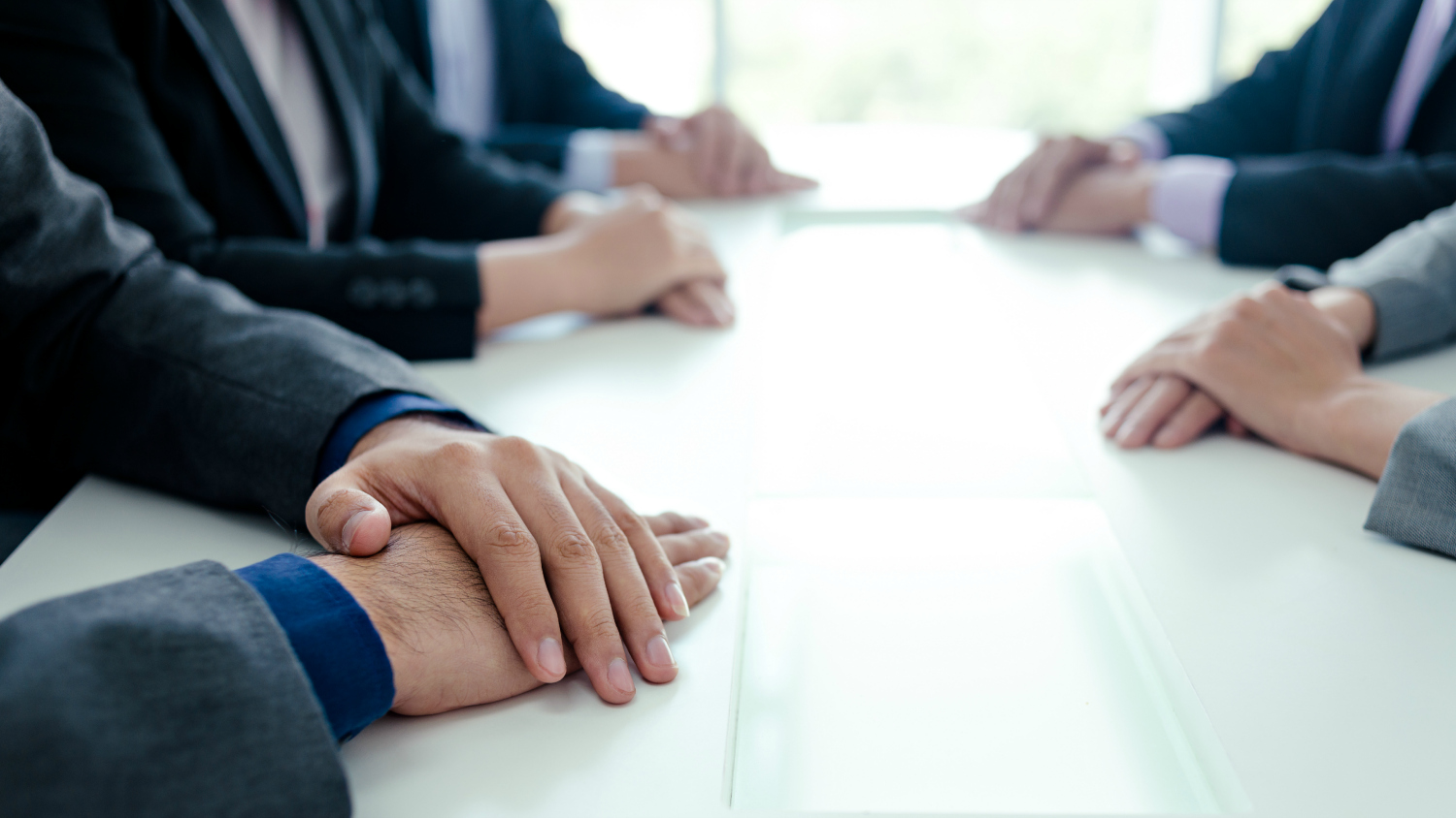 suited people at a negotiating table