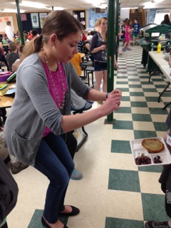 Sarah Amin snaps a picture of a student's lunch