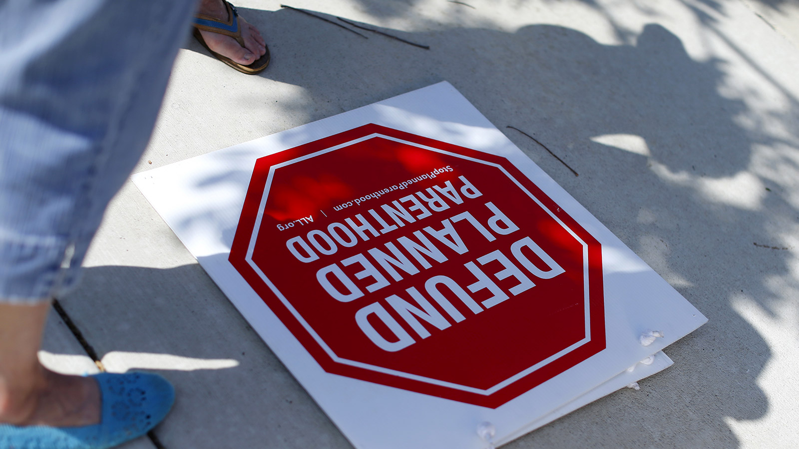 Protesters stand on a sidewalk outside a Planned Parenthood clinic in Vista, California August 3, 2015.