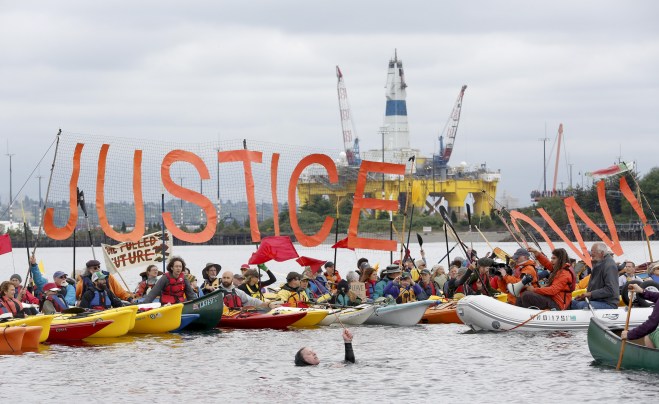 Activists protest the Shell Oil Company's drilling rig Polar Pioneer which is parked at Terminal 5 at the Port of Seattle, Washington