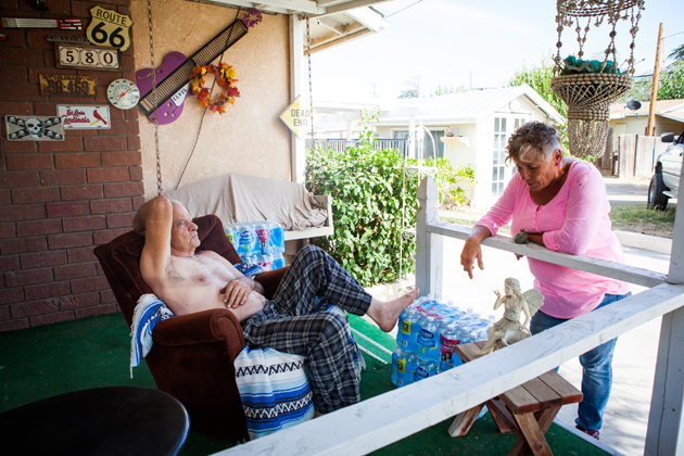 Donna Johnson drops off water for Bill Dennis, whose well went dry last month. 