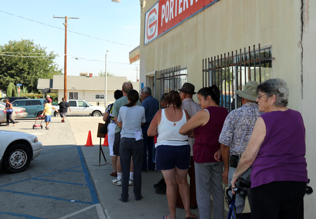 Residents line up to pick up emergency boxes of food.