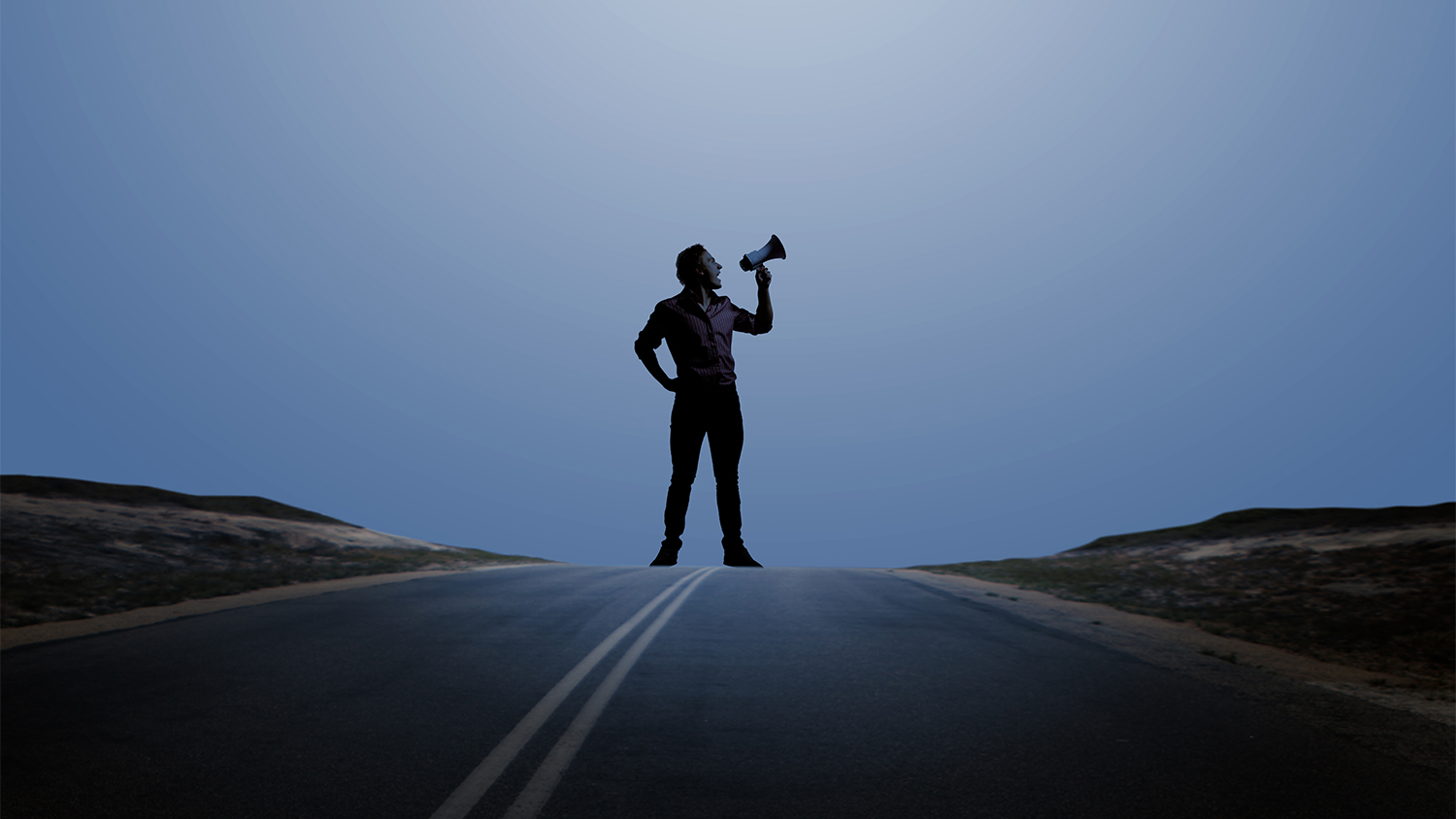 Man standing with megaphone in hand