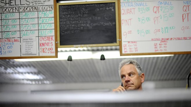 Kevin Lunny, owner of Drakes Bay Oyster Company, listens to a phone call from U.S. Interior Secretary Ken Salazar to learn that the government will not renew his family's lease 